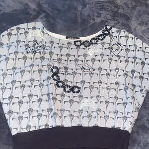 Religion off the shoulder top with beading and banded bottom.